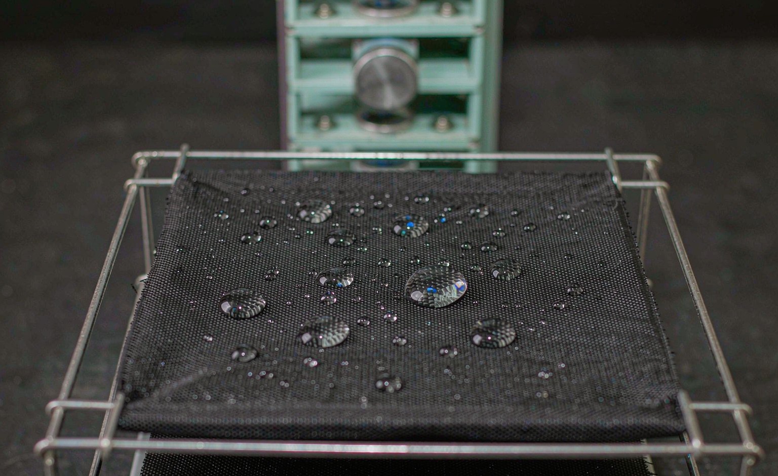 Water droplets beading on a coated technical fabric during a repellency test